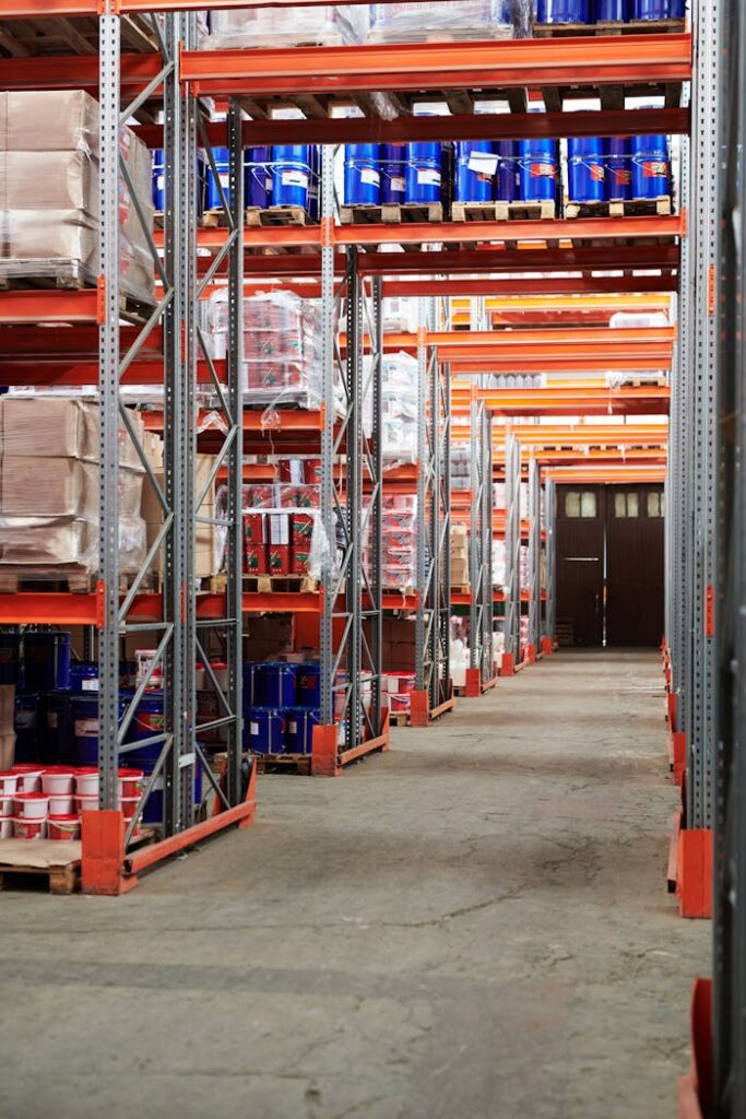 Industrial warehouse interior with organized shelves stacked with packages and goods.